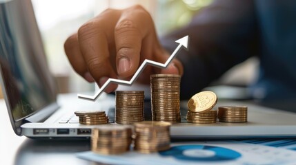 Financial Growth, Investment and Planning Symbolized by Hands Interacting with Financial Charts and Graphs and Stacking Coins on a Laptop