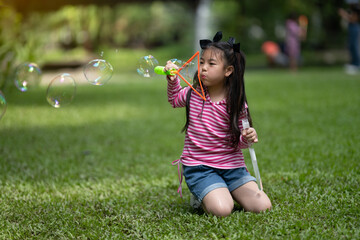 Young Girl Playing with Giant Bubble Wand