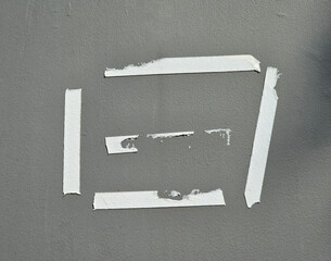 Old glue tape marks on the gray wall