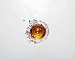 Whisky, Glass, Splashing.Glass of whiskey up with drops top view,Small flat whiskey bottle splash on white background