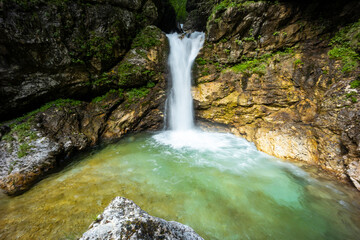 Obraz premium Rio di Repepeit. Wonderful waterfall that falls from a cliff. The force of the waterfall is a sight to behold. Hiking, trekking in the open area surrounded by woods. Summer holidays, peace.