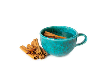 Fragrant hot tea with cinnamon stick and anise isolated on white background. A cup of hot tea with...