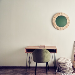The warm neutral color of the wall above the desk and chair, the concept of minimalism with space...