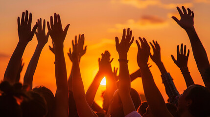 Hands to heaven, group of people with their hands up looking at the sunset
