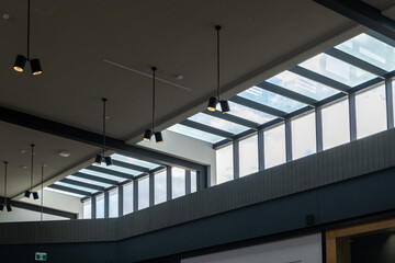 A transparent ceiling with clerestory windows. Glass panels installed high up on a wall, near the...