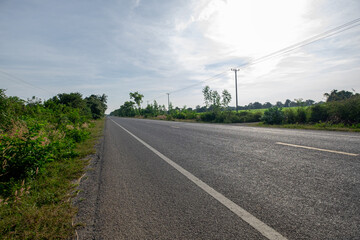 An Empty Asphalt Road in a Remote Rural Area, Surrounded by Simple, Peaceful, and Beautiful Nature