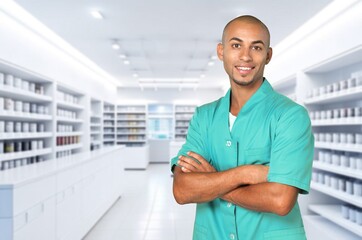 Healthcare concept, crossed arms male pharmacist in a clinic.