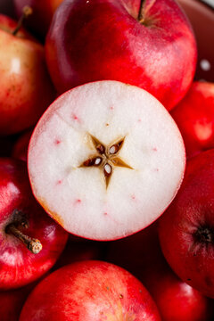 Fresh red apples, one cut in half (Close Up)