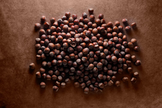 Hazelnuts on a brown background