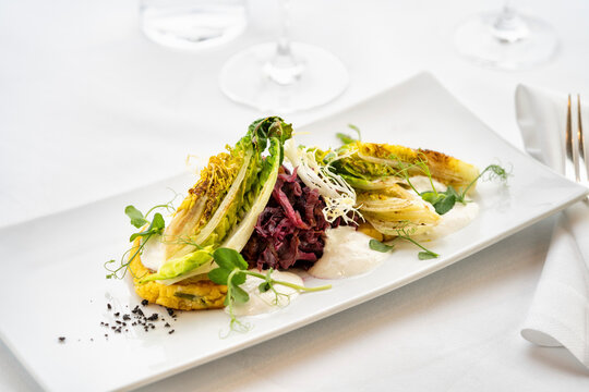 Braised lettuce hearts with red cabbage and potato fritter