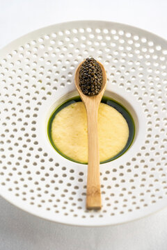 Brandade and black caviar on a wooden spoon