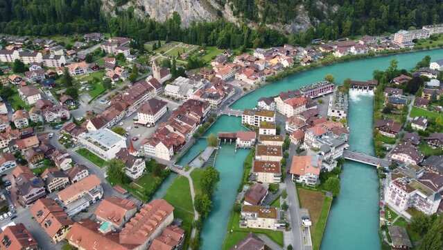 Interlaken, Switzerland: Aerial downward drone footage of the Interlaken old town with the Aar river, the market square (Marktbrunnen) and the Unterseen old church in Canton Bern