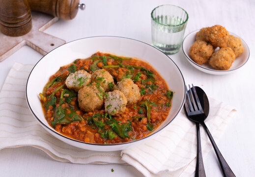 Red lentil dal with spinach and fried rice balls
