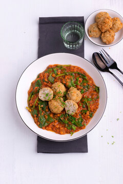Red lentil dal with spinach and fried rice balls