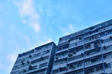 Fototapeta premium Exterior of residential building in Hong Kong with skyscape. Details of modern architecture. Building abstract. Building background.