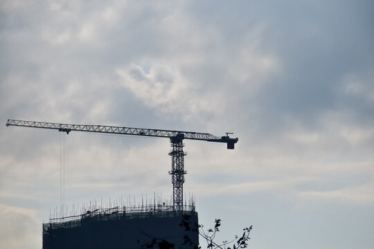 Close-up of construction crane with clear sky in background. Construction scene and city development. 