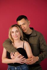 Portrait of a young positive, cheerful, international couple