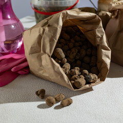 A bag filled with expanded clay stones and not food or ingredients lies on the table, waiting to be...