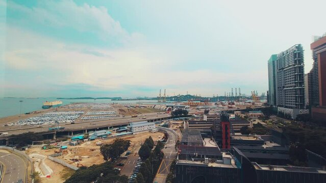 Singapore city, Singapore - 16th march, 2023: static timelapse MCE highway and cars driving by Tanjong Pagar port freight terminal. Shipping, imports exports concept asia