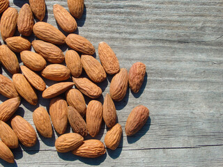 Dried almonds. Almond kernels on wooden background. Peeled almonds. Top view