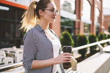 Concept of drinks and youth lifestyle, positive young woman casual dressed holding cup of coffee...