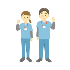 ガッツポーズをする青系のスクラブを着用した医療従事者の男女（正面を向いて笑顔全身）　
