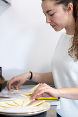 woman placing the pieces of cheese she has just cut on the plate