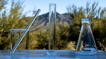 Chemicals glass containers outside in front of a mountain