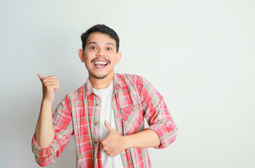 an asian man smiles and points to something with his hand, advertising concepts