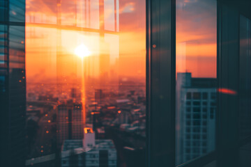 Blurred view of a sunset city from a skyscraper window