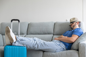 man with his hat on waiting for it to be time to go on vacation