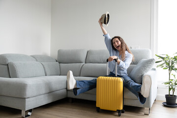 woman excited and happy holding her hat because she is going on vacation