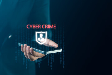 Businessman's hand holds smartphone showing cyber protection features including personal data...