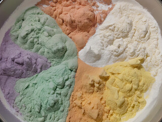 The diffusion of different colors of flour mixed together.