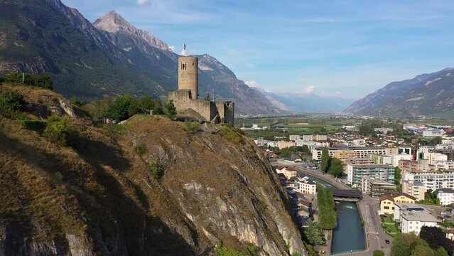 Martigny, Switzerland: Aerial drone footage of the B&acirc;tiaz medieval fort overlooking Martigny city in Canton Valais in the Swiss alps.