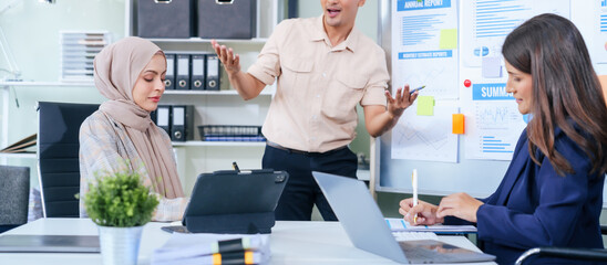 Comprehensive financial chart adorns the whiteboard during a presentation, where male and female...