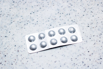 Aluminium blister pack with pills rests on a counter top