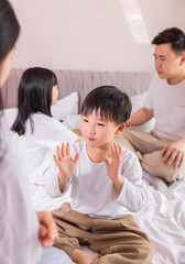 A family of four in bed in the bedroom