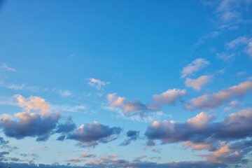 A fragment of a bright sunset sky with bizarrely shaped clouds