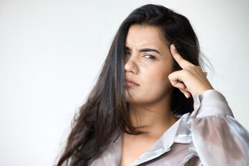 Fototapeta premium Angry Indian woman pointing at her head, body gesture for asking you to think, stop doing stupid things