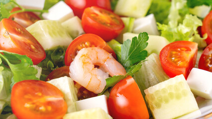 Greek salad with juicy tomatoes, feta cheese lettuce leaves green olives cucumber, fresh parsley. Homemade food