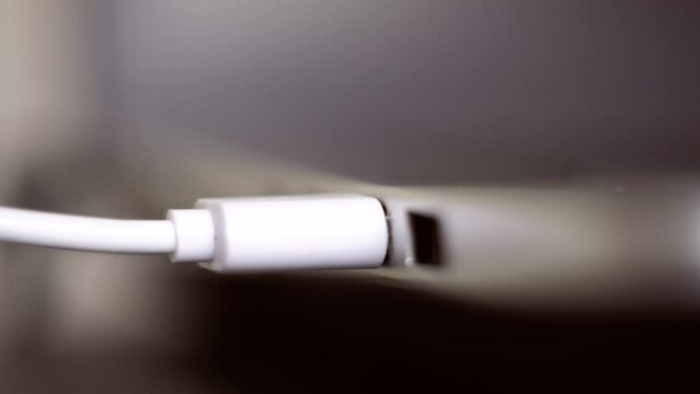 Usb hdd connected to a laptop. Hand disconnecting black USB cable to computer. Plug / unplug USB cable to laptop. Usb hdd connected to a netbook. 4K (UHD).  Macro shot 