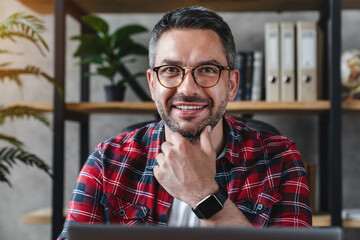 Head shot close up portrait of positive smiling caucasian freelancer businessman man in eyeglasses...
