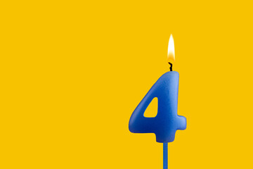 Blue birthday candle on yellow background - Number 4