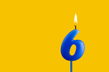 Blue birthday candle on yellow background - Number 6