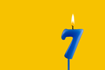 Blue candle number 7 - Birthday on yellow background