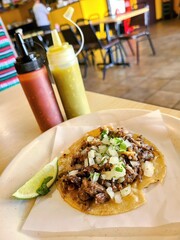 Authentic Mexican Taco with Lime and Sauces, Casual Dining Setting