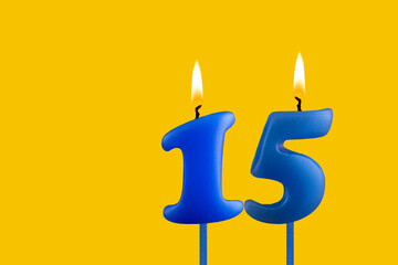Blue candle number 15 - Birthday on yellow background