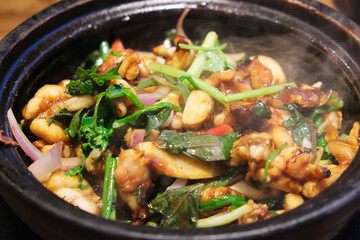 Sizzling bullfrog with Perilla frutescens in casserole. Chinese Cantonese food