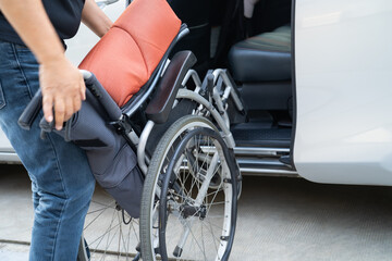 Asian disability woman on wheelchair getting in her car, Accessibility concept.